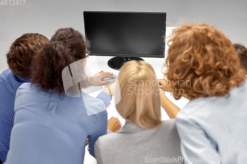 Image of business team with computer working at office