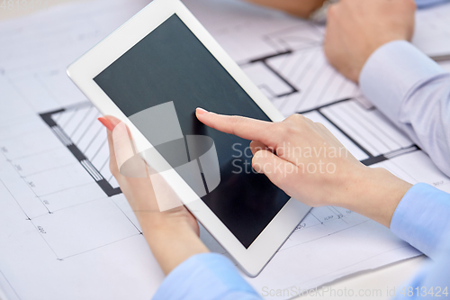 Image of architects with tablet pc and blueprint at office