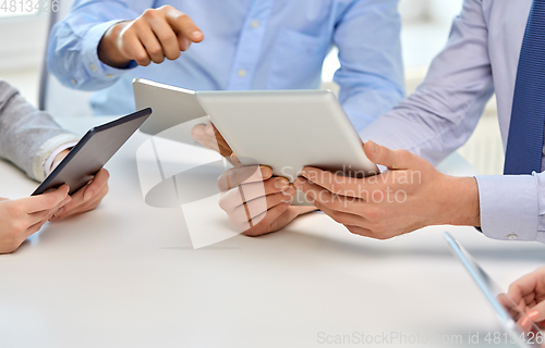 Image of close up of business team with tablet pc at office