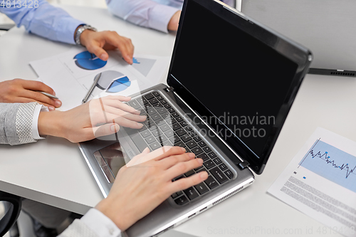 Image of close up of businesspeople with laptop at office