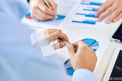 Image of close up of businessman's hands with charts