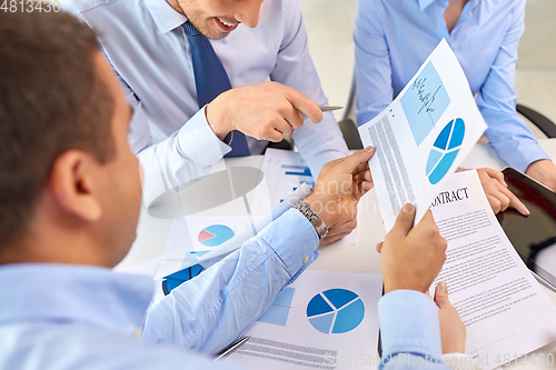 Image of close up of business team with charts at office