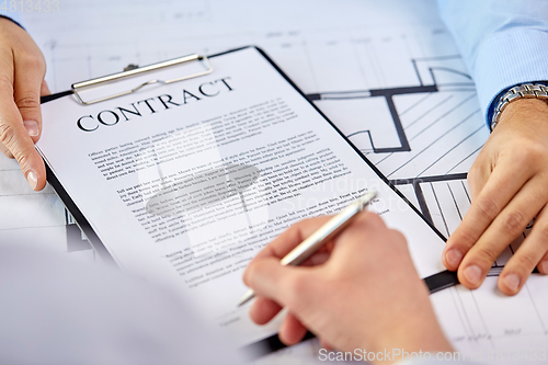Image of customer signing contract document at office