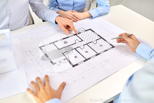 Image of close up of architects with blueprint at office