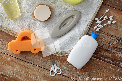 Image of baby accessories for bathing on wooden table