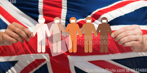 Image of hands holding people chain in medical masks