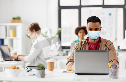 Image of indian man with laptop in medical mask at office