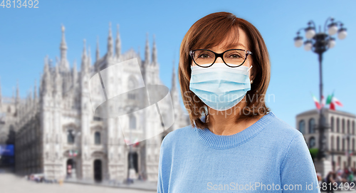 Image of senior woman in protective medical mask in italy