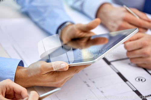 Image of architects with tablet pc and blueprint at office