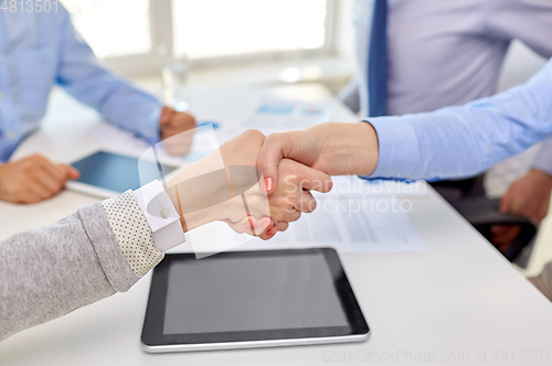 Image of close up of businesspeople making handshake