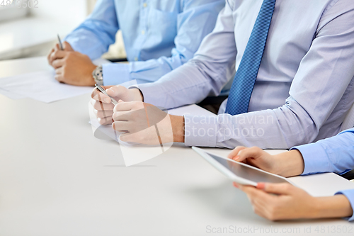 Image of hands of business people at conference at office