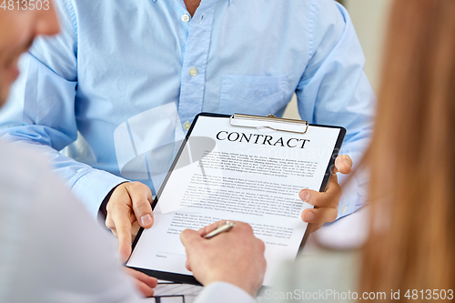 Image of customer signing contract document at office