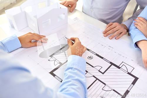 Image of close up of architects with blueprint at office