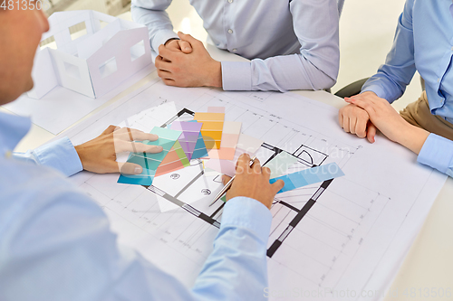 Image of close up of designers team working with blueprint