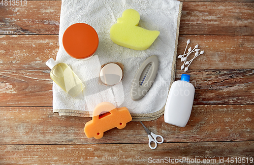 Image of baby accessories for bathing on wooden table