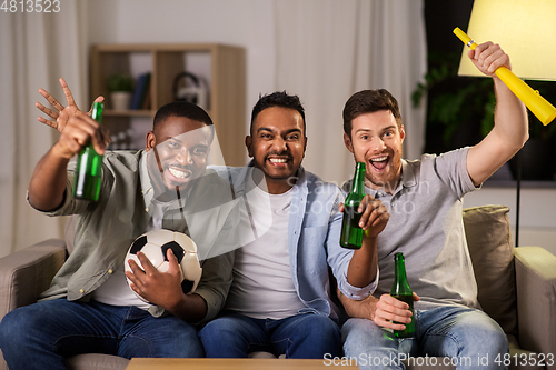 Image of friends or soccer fans with ball and beer at home