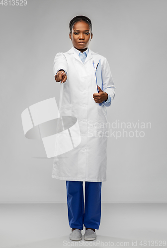 Image of african female doctor pointing finger to camera