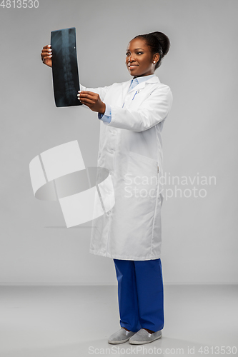 Image of african american female doctor looking at x-ray