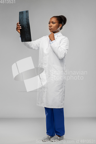 Image of african american female doctor looking at x-ray
