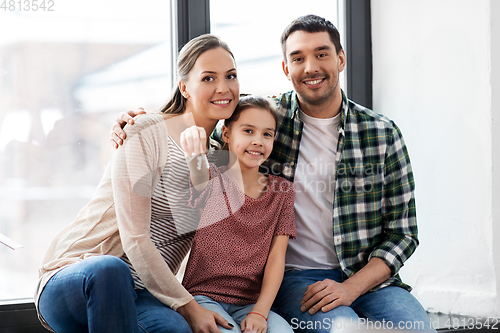 Image of happy family with house keys moving to new home