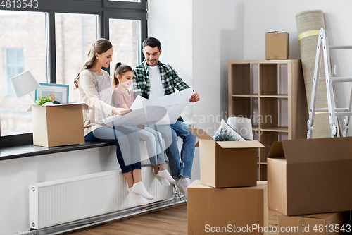 Image of happy family with blueprint moving to new home