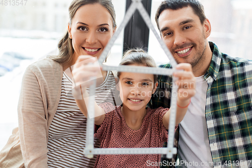 Image of happy family with folding ruler moving to new home