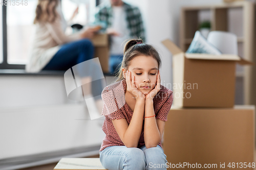 Image of sad girl moving to new home with her family