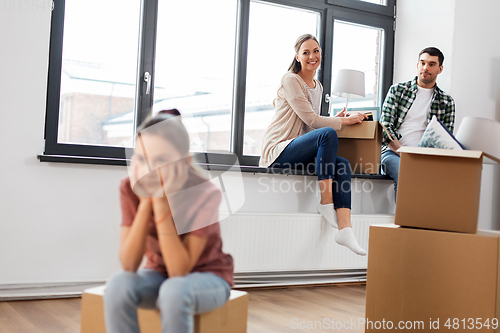 Image of sad girl moving to new home with her family