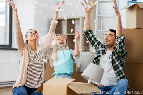 Image of happy family playing with foam peanuts at new home