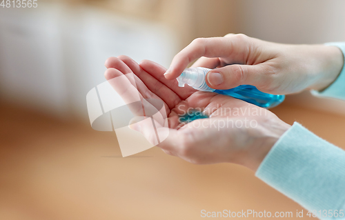 Image of close up of woman spraying hand sanitizer