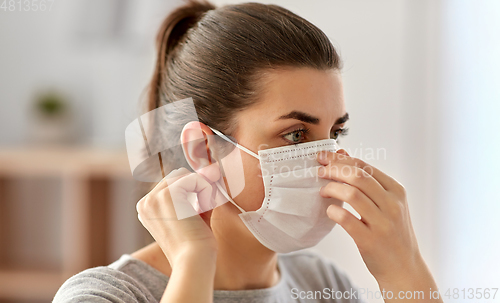 Image of young woman wearing protective medical mask