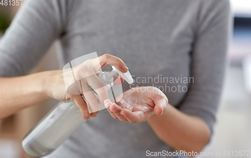 Image of close up of woman applying hand sanitizer