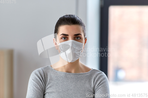 Image of young woman wearing protective medical mask