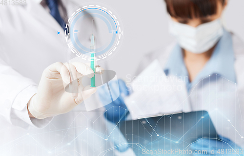 Image of close up of doctor's hand with syringe