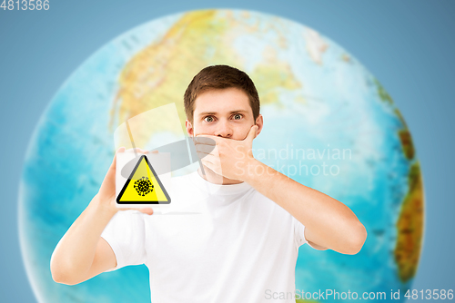 Image of scared man with coronavirus sign over earth planet