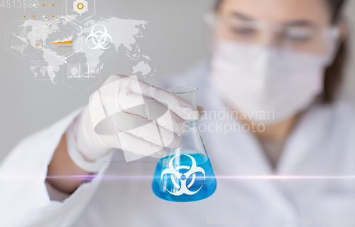Image of scientist holding test tube with biohazard symbol