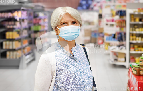 Image of senior woman in medical mask at supermarket