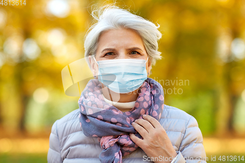 Image of senior woman in protective medical mask at park