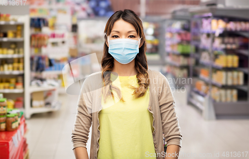 Image of asian young woman in protective medical mask