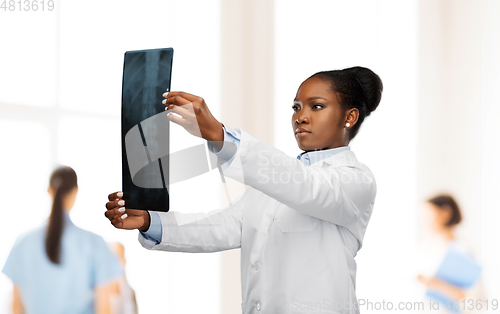 Image of african american female doctor looking at x-ray