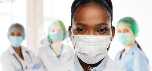 Image of african american doctor in medical mask at clinic