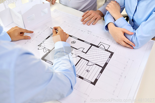 Image of close up of architects with blueprint at office