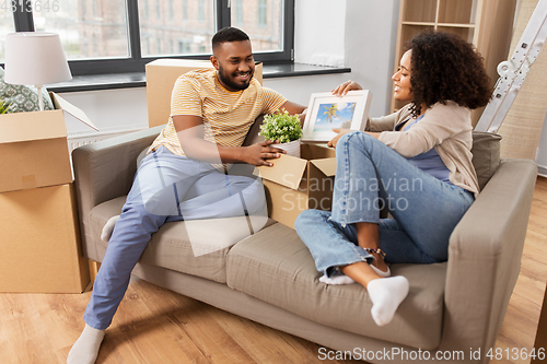 Image of happy couple with boxes moving to new home