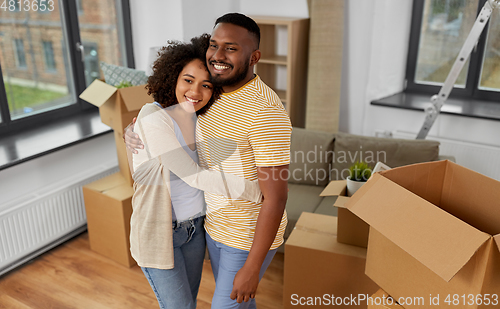 Image of happy couple with boxes moving to new home