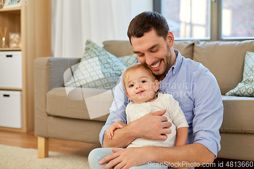 Image of father with little baby daughter at home