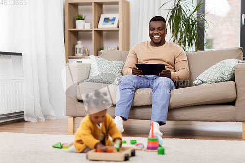 Image of happy father with tablet pc and baby at home