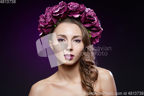 Image of beautiful girl with purple makeup and flowers