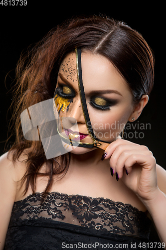 Image of beautiful young woman with zipper on face
