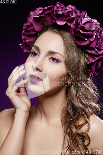 Image of beautiful girl with purple makeup and flowers