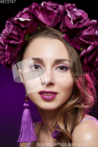 Image of beautiful girl with purple makeup and flowers